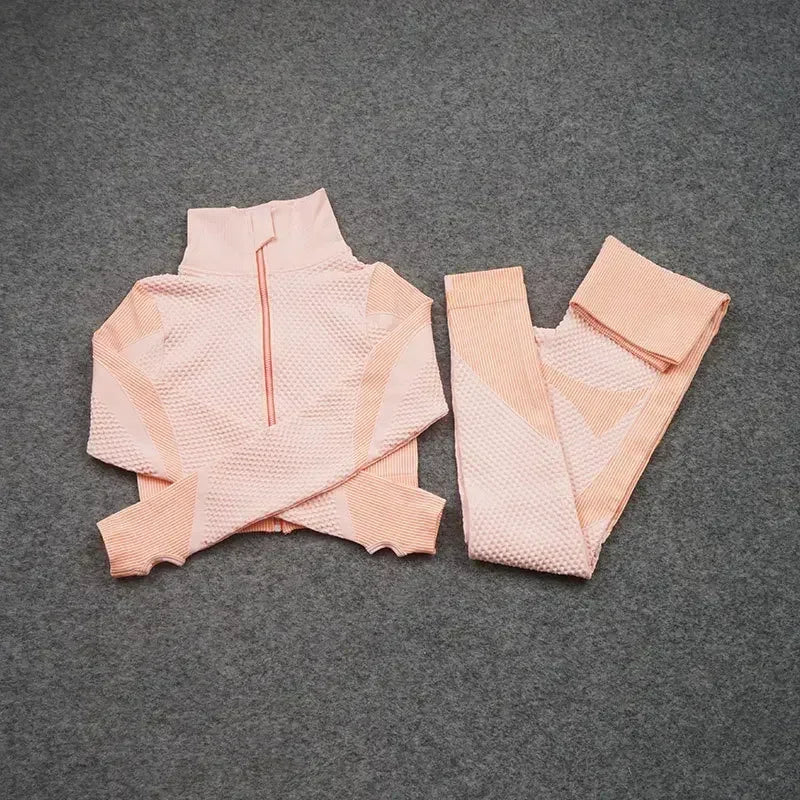 Mesh sports crop top and leggings set in pastel pink, perfect for women's workouts and athleisure wear.