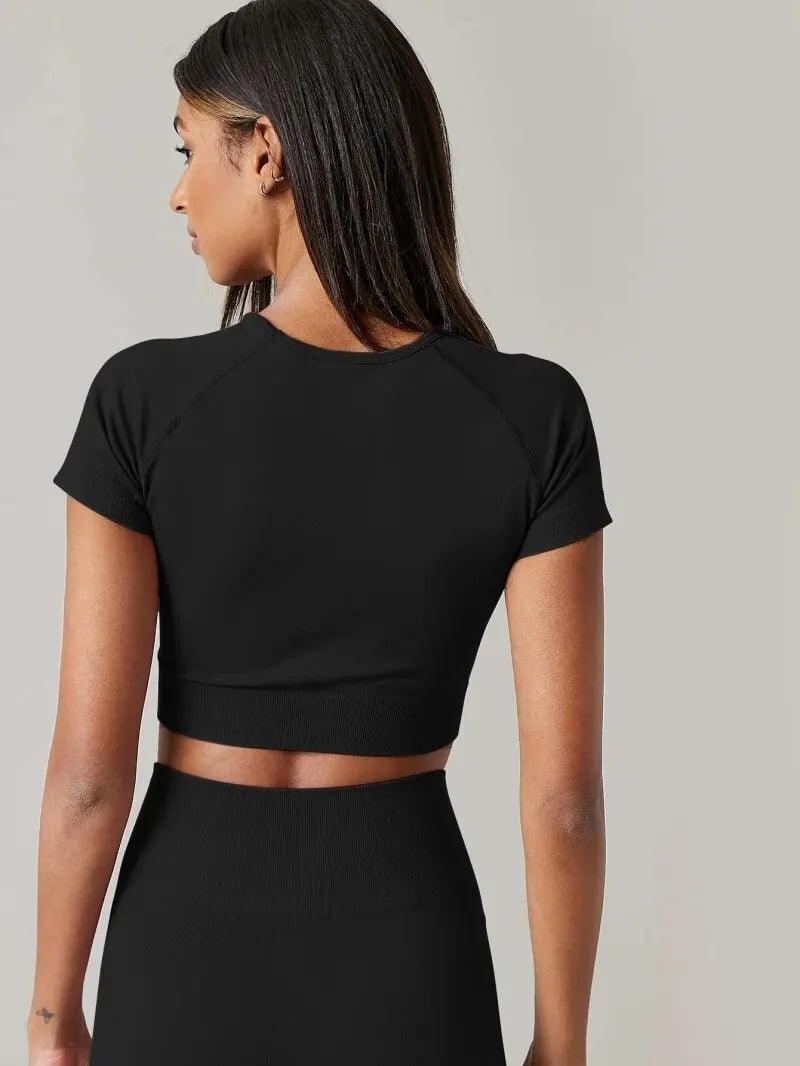 Back view of a woman in a black VivaCore Seamless Tee, showcasing its breathable, quick-dry fabric ideal for yoga.