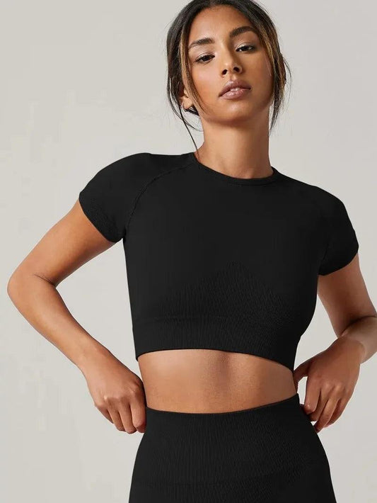 Woman wearing a black VivaCore Seamless Tee, designed for yoga, featuring a fitted, breathable, and quick-dry fabric.